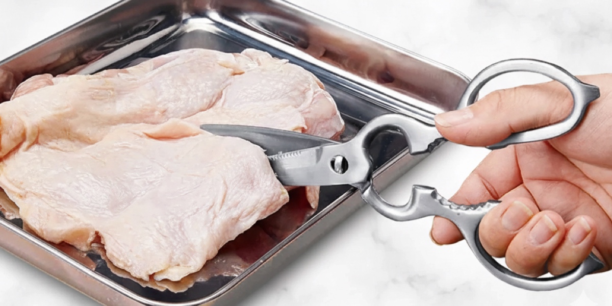 All-stainless Japanese kitchen shears slicing through raw chicken, demonstrating grip and cutting power on slippery proteins.